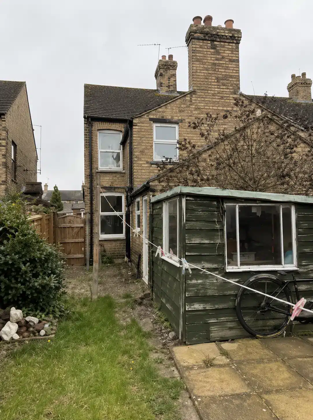 Rear of 15 Darthill Road, March, before refurbishment - rear garden, outbuilding and ground-floor rooms affected by rising damp